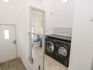 a laundry room with a washer and dryer at Ty Mawr Farm in Llanfairpwllgwyngyll