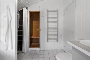 a white bathroom with a shower and a toilet at C11221-Hemmet-Egernvej-2 in Hemmet +21 photos