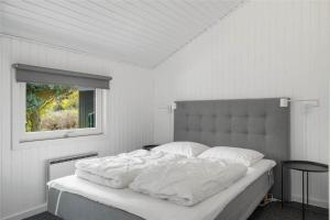 a white bedroom with a large bed with a window at C11221-Hemmet-Egernvej-2 in Hemmet