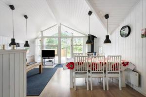 a white dining room with a table and chairs at C11221-Hemmet-Egernvej-2 in Hemmet