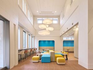 a large waiting room with tables and chairs at Centara Life Namba Hotel Osaka in Osaka +64 photos
