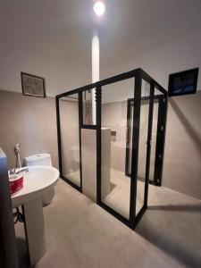 a bathroom with a toilet and a white sink at OHANA Homestay in Coron