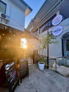 a restaurant with signs in front of a building at OHANA Homestay in Coron +9 photos
