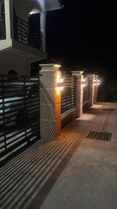 a fence with lights on the side of a building at Peaceful Paraiso in New Amsterdam