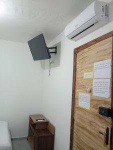a room with a door and a speaker on the wall at FLAT PERTO do centro de convenções e Chevrolet Hall in Recife