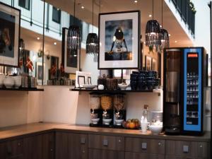 a coffee shop with a counter with food on it at Dancenter Hotel Jomfru Ane Standard Double in Aalborg +27 photos