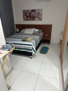 a bedroom with a bed and a tiled floor at Casa Condomínio Reserva do Delta in Parnaíba +14 photos