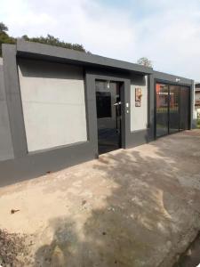 a building with two garage doors in a driveway at Small and cozy in Ijuí