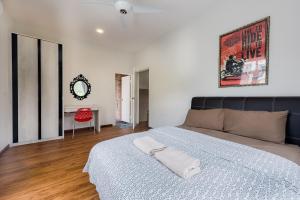 a bedroom with a large bed and a mirror at New Shamrock Beach Villas Seaview in Batu Ferringhi