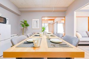 a dining room with a table and chairs at 弥富民泊 - Yatomi Minpaku - in Yatomi  +20 photos
