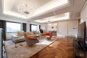 a living room with a couch and chairs and a chandelier at Hotel Interburgo Daegu in Daegu