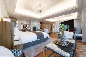 a bedroom with a large bed and a living room at Hotel Interburgo Daegu in Daegu +77 photos