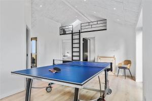 a ping pong table in a room with a ceiling at 8912-Allingabro-Fyrrevej-6 in Allingåbro
