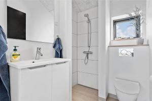 a white bathroom with a sink and a toilet at 8912-Allingabro-Fyrrevej-6 in Allingåbro +29 photos