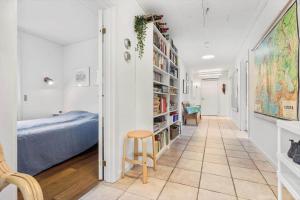 a hallway with a bedroom and a bed and a stool at 8592-Glesborg-Muslingevej-9 in Glesborg