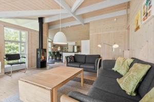 a living room with a couch and a table at 8995-Orsted-Alsikevej-9 in Ørsted