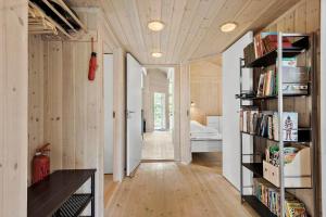 a room with a book shelf and a bedroom at 8995-Orsted-Alsikevej-9 in Ørsted