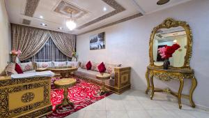 a living room with a couch and a mirror at Abraj Dubai - Premium 3BR Stay in Heart of Larache in Larache