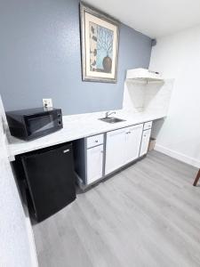 a kitchen with a sink and a microwave at Economy Inn in Longview