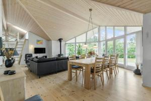 a dining room and living room with a table and chairs at 8920-Orsted-Ternevej-16 in Ørsted