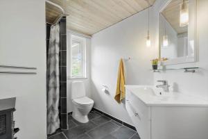 a white bathroom with a toilet and a sink at 8920-Orsted-Ternevej-16 in Ørsted +25 photos
