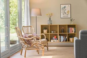 a living room with two chairs and a book shelf at 8915-Glesborg-Zachosvej-5 in Glesborg