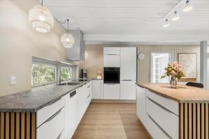 a kitchen with white cabinets and a counter top at 8915-Glesborg-Zachosvej-5 in Glesborg +17 photos