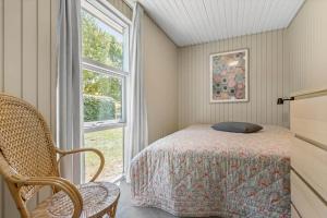 a bedroom with a bed and a window at 8915-Glesborg-Zachosvej-5 in Glesborg