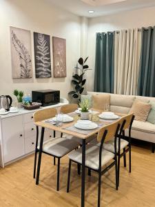 a dining room table and chairs in a living room at Lafontana Hometel in Roxas City