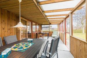 a dining room with a wooden table and chairs at 8503-Grenaa-Ellevej-29 in Grenå