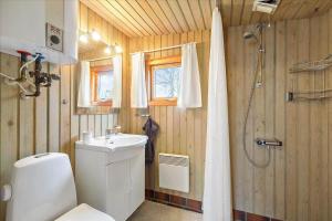 a bathroom with a toilet and a sink and a shower at 8503-Grenaa-Ellevej-29 in Grenå