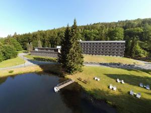 an aerial view of a building next to a body of water at Sunday Schwarzbachtal Double Room Forest View in Erlbach