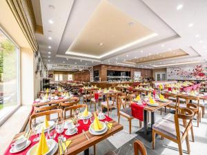a dining room with wooden tables and chairs at Sunday Schwarzbachtal Double Room Forest View in Erlbach +32 photos