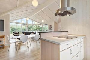 a kitchen and dining room with a table and chairs at 8519-Grenaa-Nobilisvej-13 in Grenå