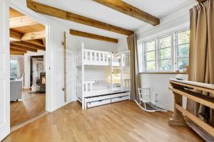 a bedroom with white walls and wooden ceilings at 8514-Grenaa-Sortebaervej-16 in Grenå