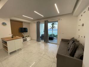 a living room with a couch and a view of the ocean at Laguna Azul Boca Beach in Boca Chica