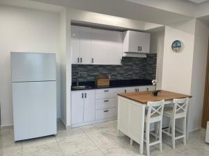a kitchen with a white refrigerator and a table at Laguna Azul Boca Beach in Boca Chica