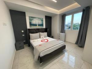 a bedroom with a bed with a red ribbon on it at Laguna Azul Boca Beach in Boca Chica +16 photos