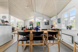 a kitchen and dining room with a table and chairs at 8908-Allingabro-Poppelvej-7 in Allingåbro