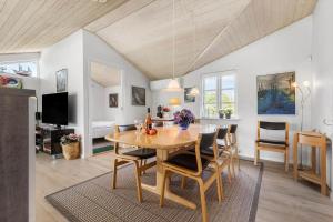 a dining room with a table and chairs at 8908-Allingabro-Poppelvej-7 in Allingåbro