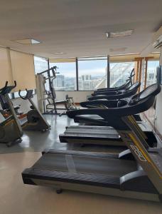 a gym with treadmills and machines in a room at Sol Alphaville Hotel & Residence 1004 in Barueri