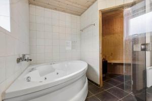 a white bath tub in a bathroom with a window at 8848-Glesborg-Floden-4 in Glesborg