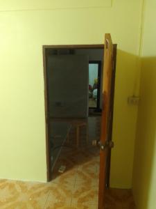 an open door to a room with a mirror at รีสอดเวล์ in Samutprakarn