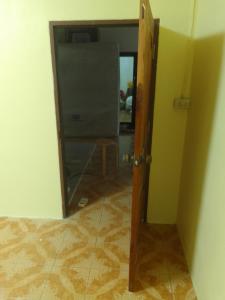 an open door to a room with a mirror at รีสอดเวล์ in Samutprakarn