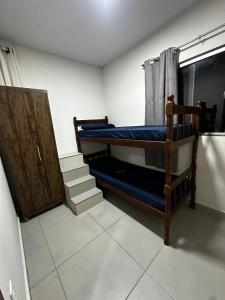 a room with two bunk beds and a window at Hostel Salazar in Campo Grande
