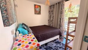 a small bedroom with a bed and a staircase at Casa Alexa - Island Escape in Puerto Princesa City