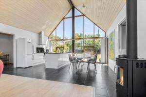 a kitchen and dining room with a table and chairs at 8565-Grenaa-Kystvej-58 in Grenå +18 photos