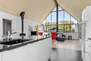 a kitchen with a sink and a living room at 8565-Grenaa-Kystvej-58 in Grenå