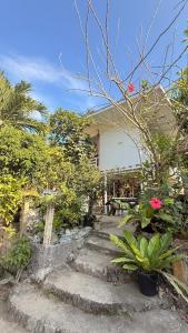 a set of stairs in front of a house with plants at Casa Alexa - Island Escape in Puerto Princesa City