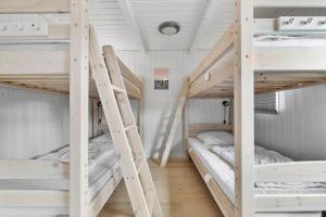 two bunk beds in a room with white walls at 8927-Allingabro-Nordvangsvej-27 in Allingåbro +19 photos